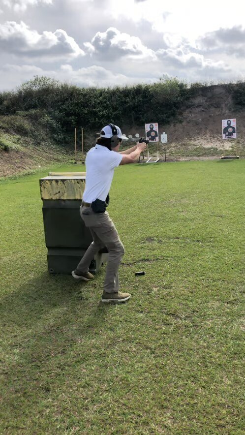 John Johnson instructing at an indoor shooting range